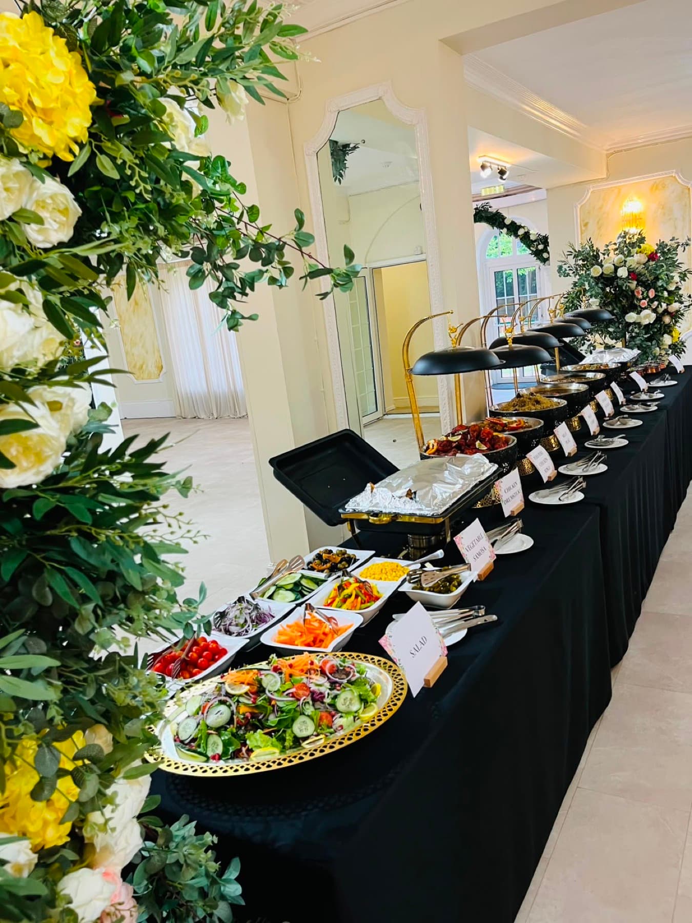 A hot buffet spread with labelled dishes, catered by Blotts